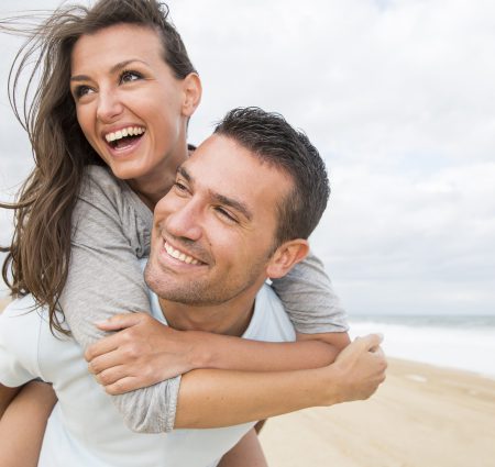Glimlach jongen en meisje op het strand